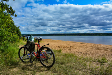 Fototapeta premium Two bicycles on the shore of the lake