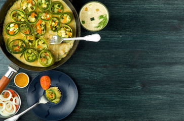 Zucchini in the background. Fried young sliced courgettes in a pan on a dark background. The view from the top. Copy space