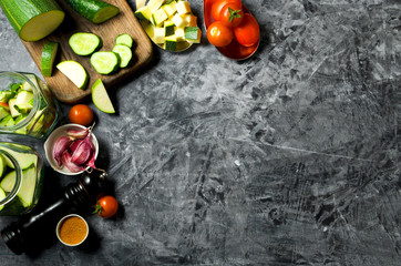 Vegetables on the background. Fresh vegetables (cucumbers, tomatoes, onions, garlic, dill, green beans) on a gray background. Top view. Copy space