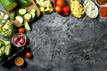 Vegetables on the background. Fresh vegetables (cucumbers, tomatoes, onions, garlic, dill, green beans) on a gray background. Top view. Copy space