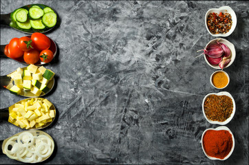 Vegetables on the background. Fresh vegetables (cucumbers, tomatoes, onions, garlic, dill, green beans) on a gray background. Top view. Copy space