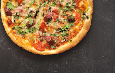 Delicious pizza on dark board.