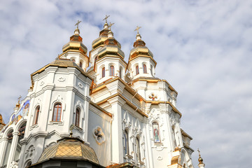 Fototapeta premium Temple of The Myrrh-Bearers. Orthodox church with a golden shining dome in the city of Kharkiv
