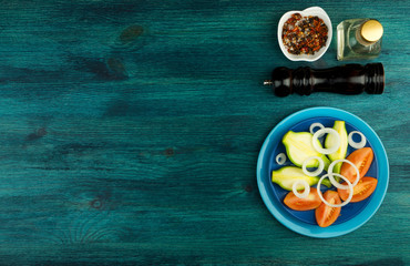 VEGETABLES ON BACKGROUND. FRESH VEGETABLES AND SPICES ON A WOODEN SURFACE. COPY SPACE