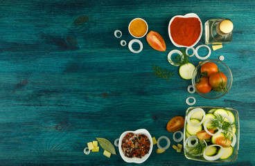 VEGETABLES ON BACKGROUND. FRESH VEGETABLES AND SPICES ON A WOODEN SURFACE. COPY SPACE