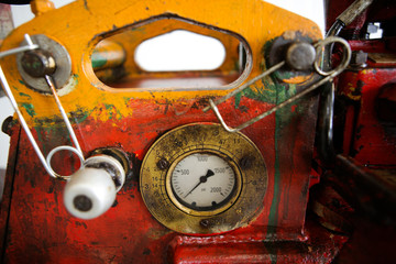 Details of a steampunk like old, dirty, colorful and rusty PSI manometer on an industrial heavy...
