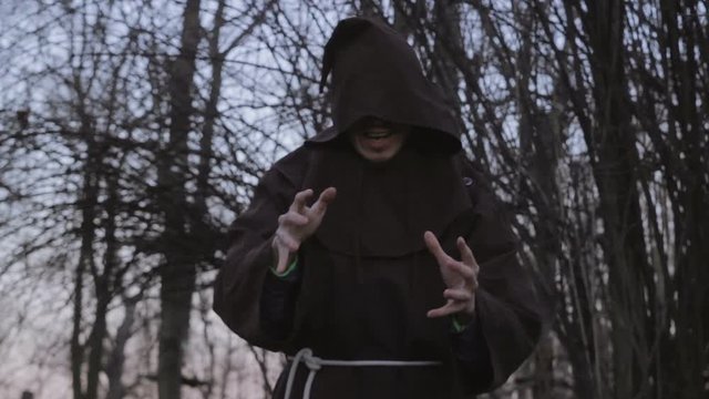Medieval Necromancer Mumbling Сurses In A Forest