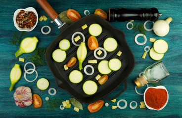 VEGETABLES ON BACKGROUND. FRESH VEGETABLES AND SPICES NEAR A FISHING SET ON A WOODEN SURFACE. COPY SPACE