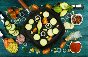 VEGETABLES ON BACKGROUND. FRESH VEGETABLES AND SPICES NEAR A FISHING SET ON A WOODEN SURFACE. COPY SPACE