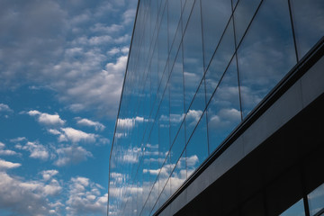 Fototapeta na wymiar Modern Building with Glass Windows Reflecting Sky