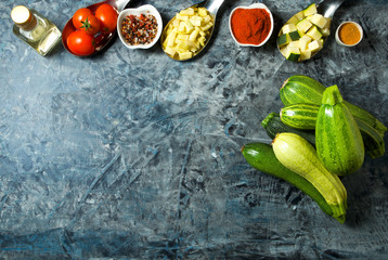 Vegetables on the background. Fresh vegetables (cucumbers, tomatoes, onions, garlic, dill, green beans) on a gray background. Top view. Copy space