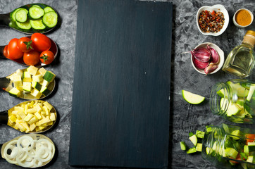 Vegetables on the background. Fresh vegetables (cucumbers, tomatoes, onions, garlic, dill, green beans) on a gray background. Top view. Copy space