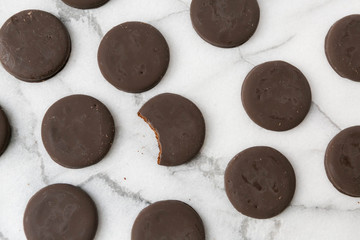 thin mints cookies on white marble background, chocolate mint thin round cookies