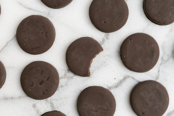 thin mints cookies on white marble background, chocolate mint thin round cookies