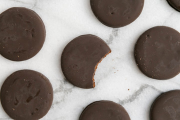 thin mints cookies on white marble background, chocolate mint thin round cookies