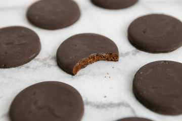thin mints cookies on white marble background, chocolate mint thin round cookies
