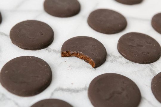 thin mints cookies on white marble background, chocolate mint thin round cookies