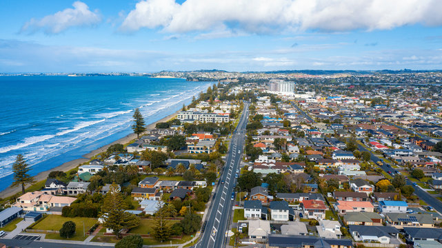 Aerial View from the Beach, Green Trees and City Streets of Orewa in New Zealand - Auckland Area