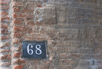 Fototapeta na wymiar Number 68 on a Brick Wall