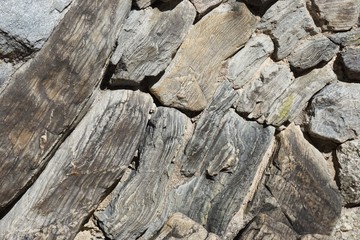 Natural rough stone fence with irregular interlocking shapes