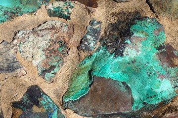 Rough stone boulder with colorful green malachite inclusions © John