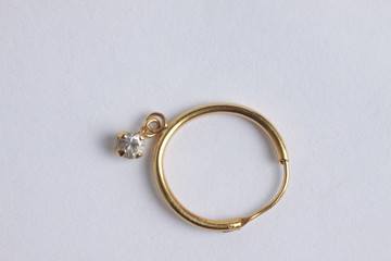 close up shot of gold ear ring on a white isolated background