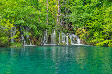 Beautiful Plitvice Lakes National Park in Croatia during the summer. Waterfalls and lakes complete this lush wonderland.