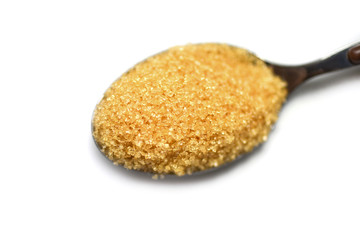 brown sugar in a spoon on white background
