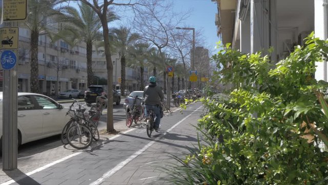 Cyclist on Shlomo Ibn Gabirol Street during spring, Tel Aviv, Israel, Middle East