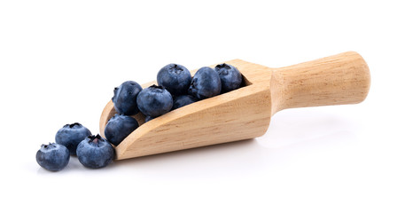 Blueberries in wood scoop  isolated on white background