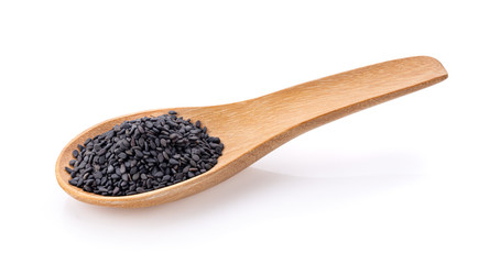 black sesame in  wood spoon isolated on white background. full depth of field