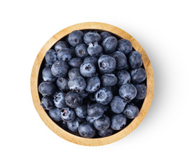 Blueberries in wood bowl  isolated on white background. top view