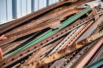 Pile of rusted steel fence posts on the ground