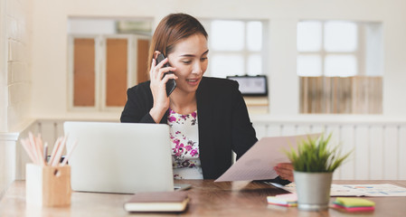 Businesswoman talking with customer on smartphone