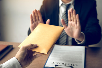 Businessmen are holding cash envelopes in order to bribe with the investment project participants...