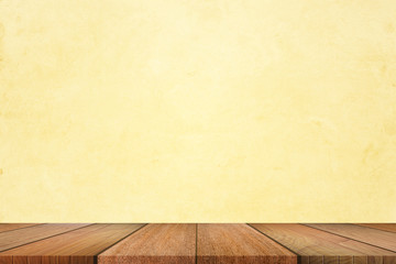 Empty of wooden table top on light yellow pastel color background. For your product display or design.