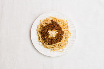 Delicious plate of noodles with meat on white textured background