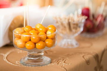 Fresh golden berry in a glass on a brown tablecloth