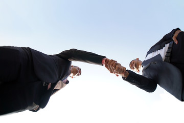 Businessmen handshaking after successful business meeting, negotiation. Perspective shoot from...