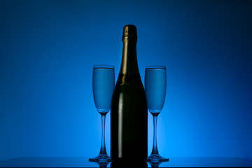 a bottle of champagne with two glasses