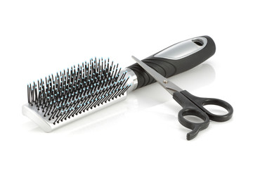 Hair brush and scissors isolated on white