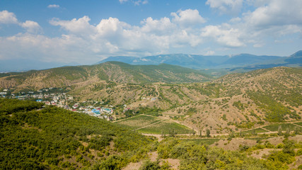 Fototapeta na wymiar Crimea landscape: aerial view of vineyards in the lowlands of the mountain. Crimean vineyards.