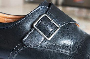 Black men's shoes on the buckle without laces.