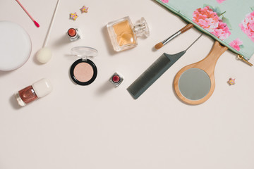 Make up bag with cosmetics on  color background