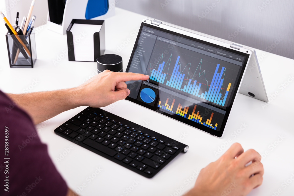 Poster businessman analyzing graph on computer