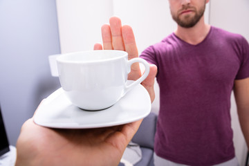 Man Refusing Cup Of Coffee
