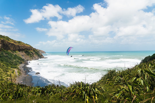 Spectacular View of Muriwai Beach, Auckland Area, North Island of New Zealand.  Muriwai is  a Popular Recreational area for Aucklanders. Paragliding, Sport, Vacation, Leisure Activity, Travel