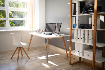 Computer On Desk In Modern Office