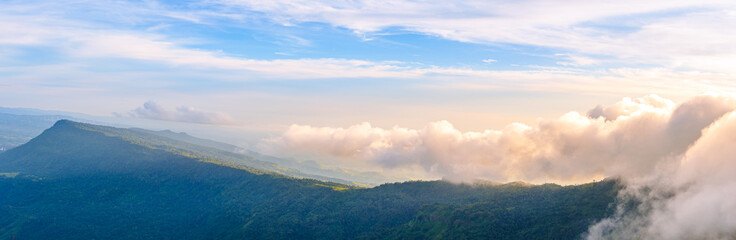Panoramic landscape, clouds moving over mountain. Foggy morning landscape and ray of sunlight at Phu Tub Berk, Phetchabun, Thailand. It’s extremely popular vacation spot for refreshing cool climate.