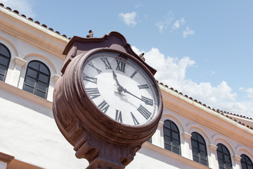 A vintage clock tower and classic architecture with a cloudy sky
